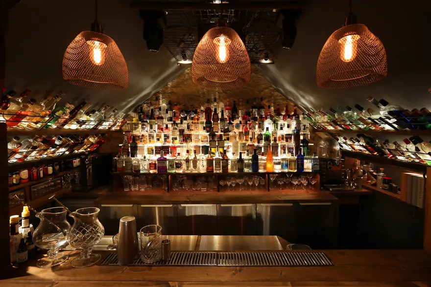 An array of gin bottles on a wooden bar